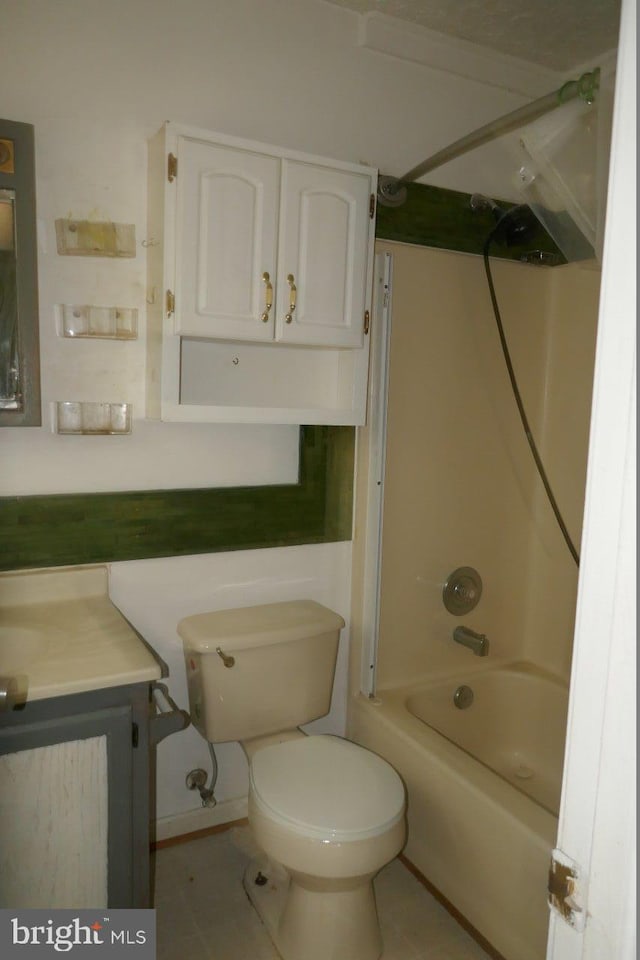 full bathroom with tub / shower combination, vanity, tile patterned flooring, and toilet