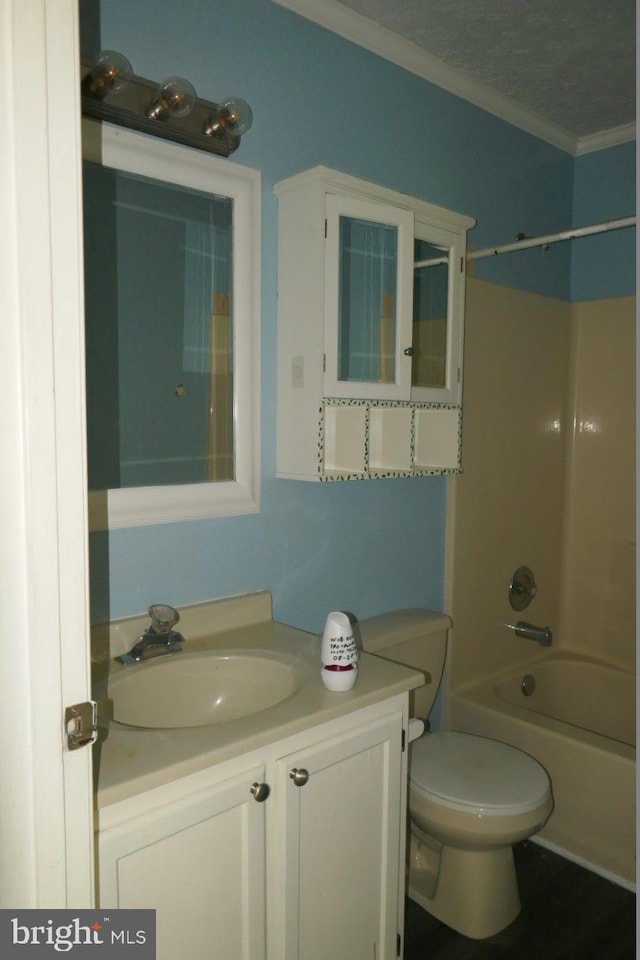 full bathroom with vanity, a textured ceiling,  shower combination, crown molding, and toilet