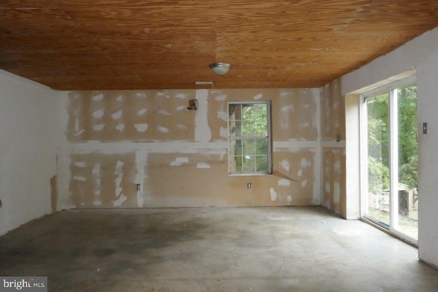 interior space with concrete flooring and wooden ceiling