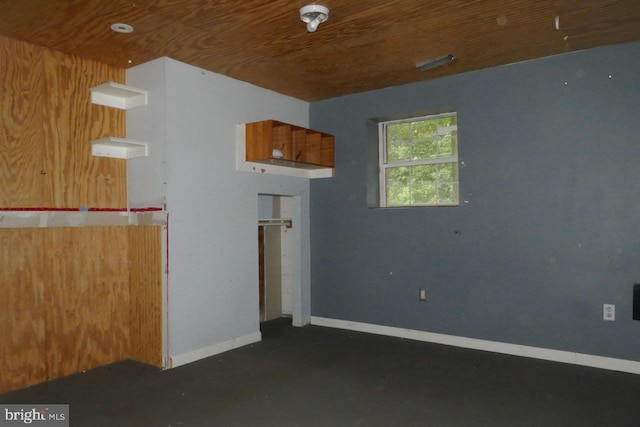 interior space featuring wood walls and wooden ceiling