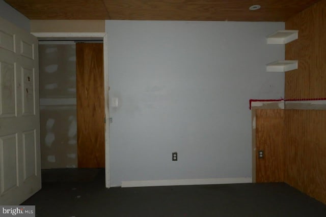 empty room featuring wood walls