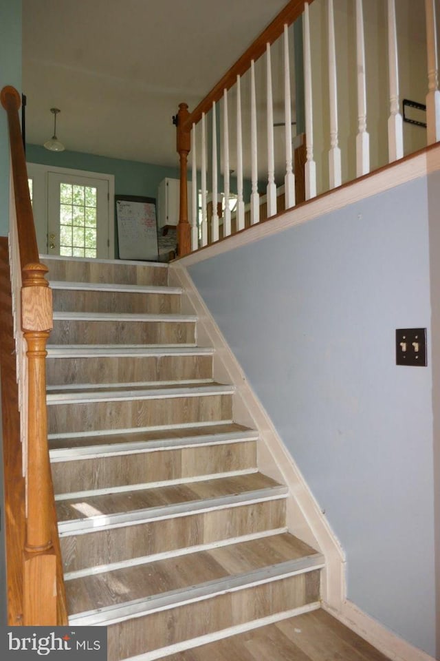 staircase with hardwood / wood-style flooring