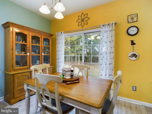 dining area featuring light hardwood / wood-style floors and a chandelier