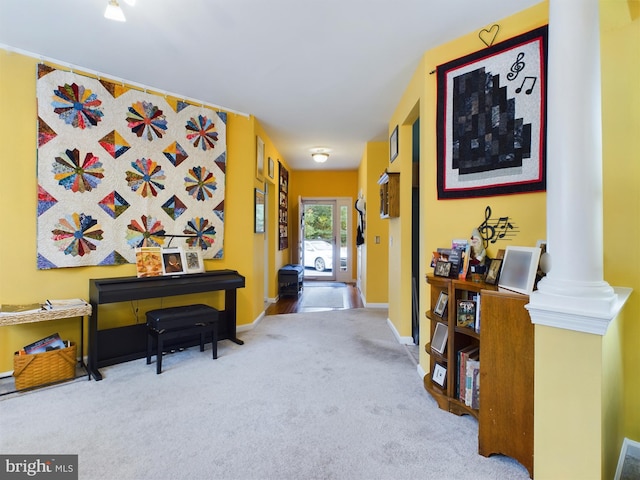 misc room with decorative columns and light colored carpet