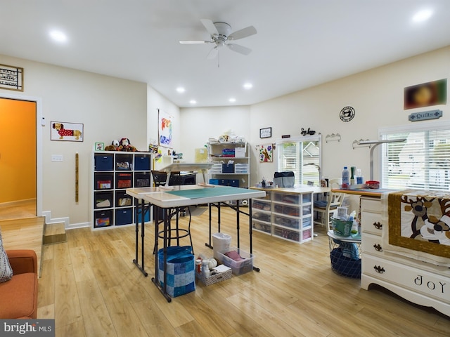 interior space with light wood-type flooring, ceiling fan, and plenty of natural light