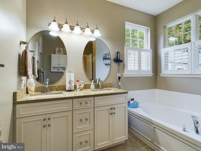 bathroom with vanity, a bathing tub, and tile patterned floors