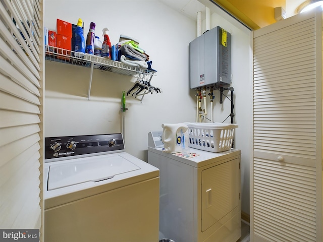 clothes washing area featuring washer and clothes dryer and tankless water heater