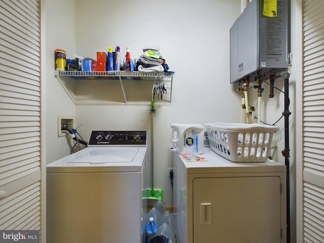 laundry area with washer and clothes dryer and water heater