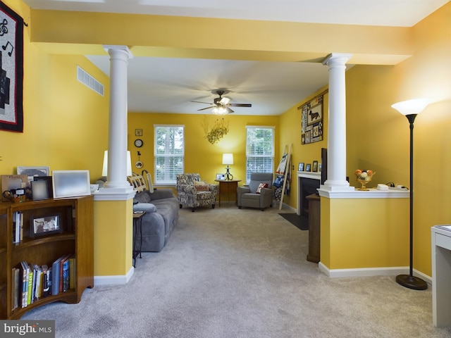 living room featuring light carpet, ceiling fan, and ornate columns