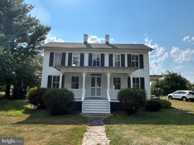 colonial home featuring a front yard and a porch