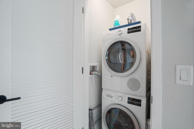 laundry room with stacked washer and clothes dryer