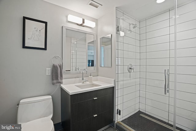 bathroom featuring walk in shower, vanity, and toilet