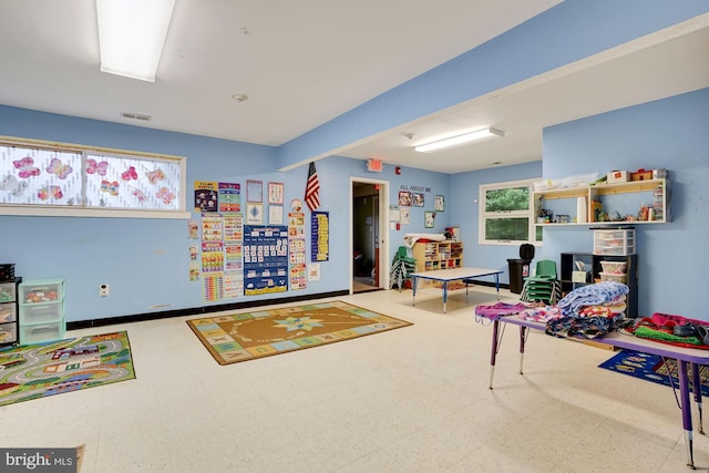 playroom featuring beamed ceiling