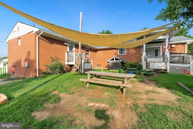 rear view of house with a lawn