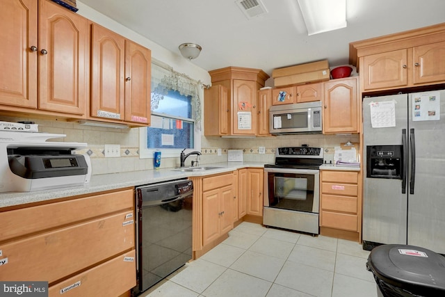 kitchen with backsplash, light tile patterned flooring, sink, and stainless steel appliances