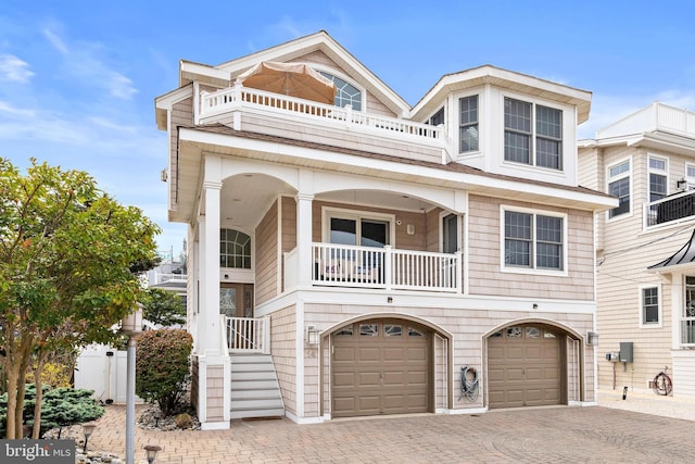 view of front of property with a balcony and a garage