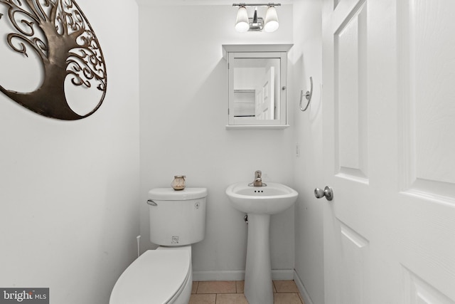 bathroom with sink, tile patterned floors, and toilet