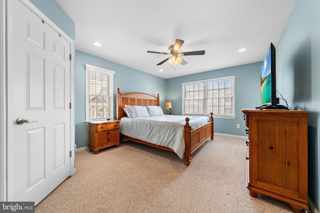 bedroom featuring ceiling fan and light carpet