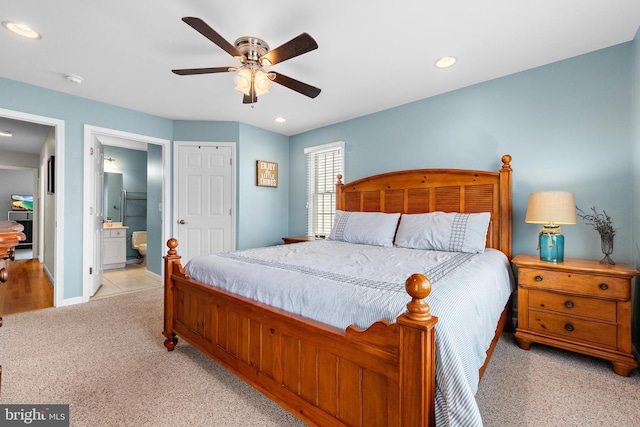 carpeted bedroom with connected bathroom and ceiling fan