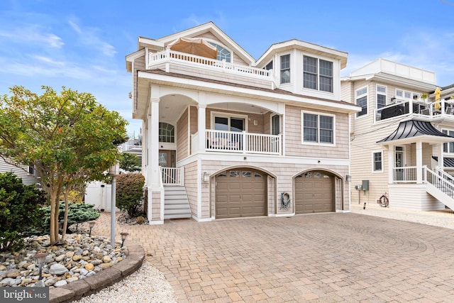 view of front of property featuring a balcony and a garage