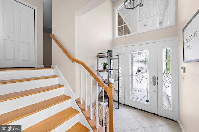 entryway with a towering ceiling