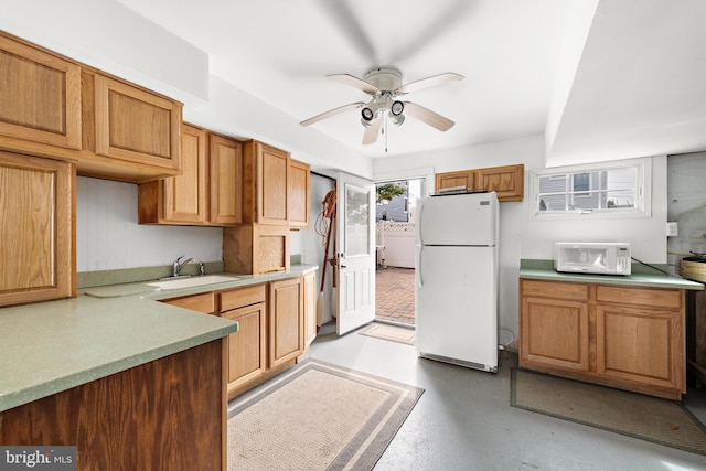 kitchen with white appliances, ceiling fan, and sink