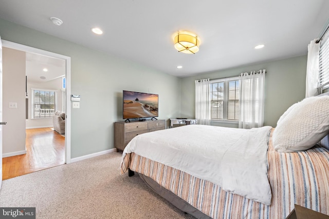 bedroom with light wood-type flooring and multiple windows