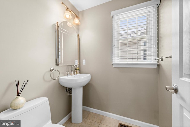 bathroom featuring toilet and tile patterned floors