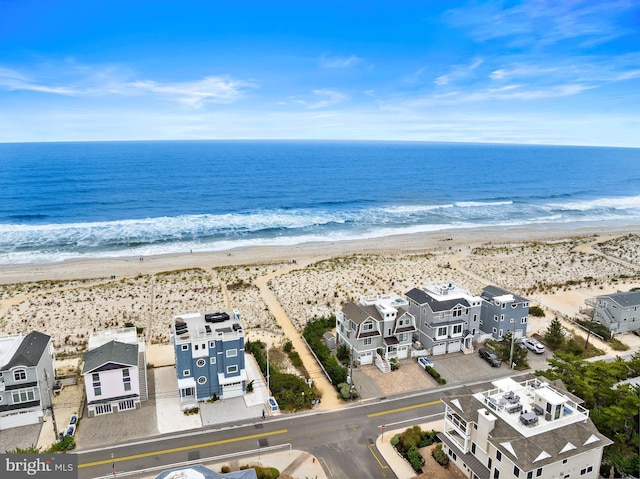 drone / aerial view with a water view and a view of the beach