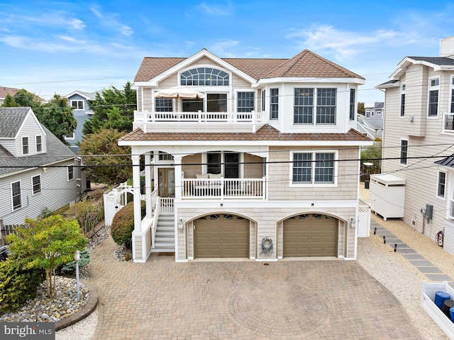 view of front of home with a balcony and a garage