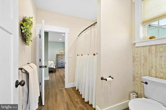 bathroom featuring wood-type flooring and toilet