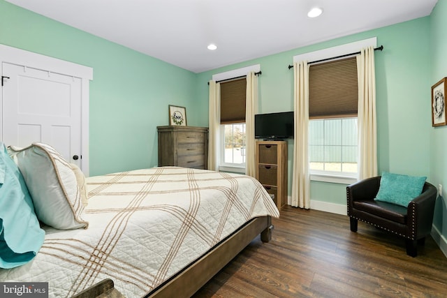 bedroom with dark hardwood / wood-style flooring