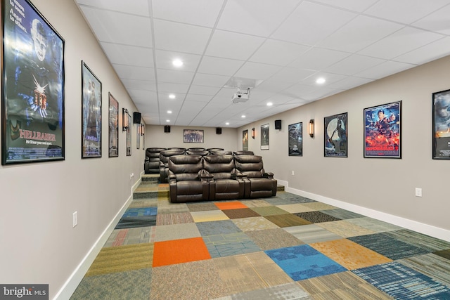 cinema with carpet flooring and a drop ceiling