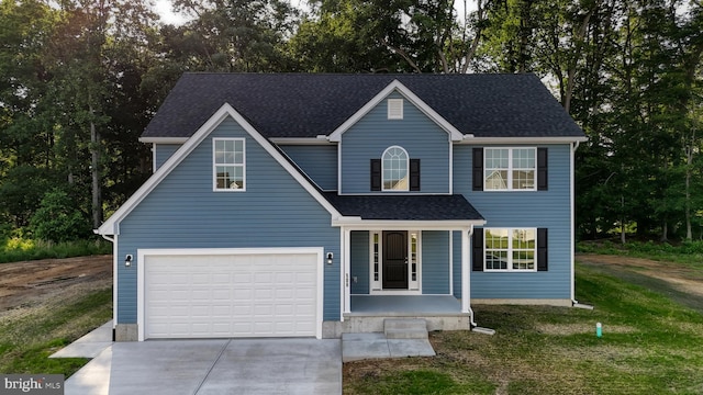 view of front of home featuring a front lawn, a porch, and a garage