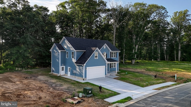 view of front of property featuring a front yard and a garage