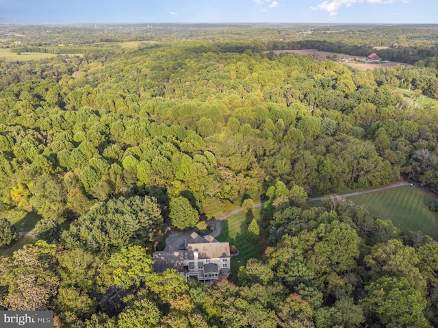 drone / aerial view featuring a forest view