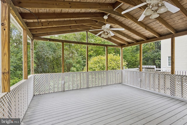 unfurnished sunroom featuring a ceiling fan