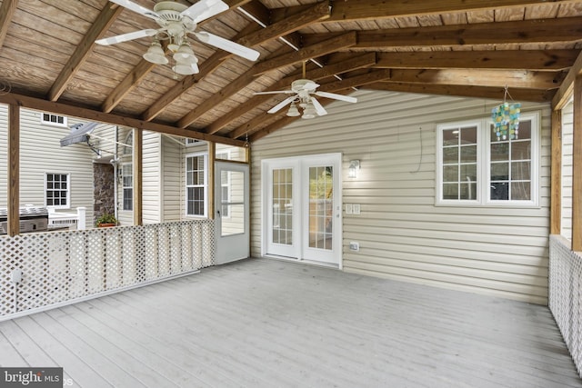 unfurnished sunroom featuring ceiling fan, vaulted ceiling with beams, and wooden ceiling