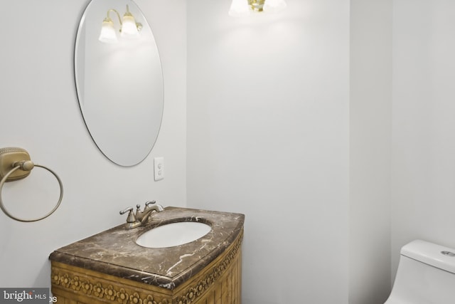 half bathroom featuring toilet and vanity