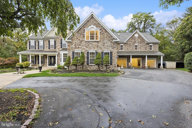 view of front of house featuring covered porch and a garage