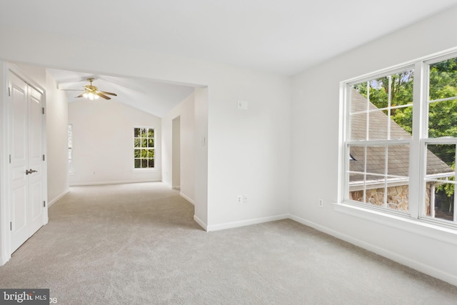 unfurnished room with ceiling fan, light colored carpet, and lofted ceiling