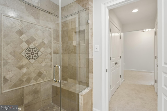 bathroom featuring a shower with shower door