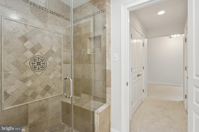 full bath featuring a stall shower and baseboards