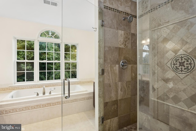 bathroom featuring plus walk in shower and tile patterned flooring