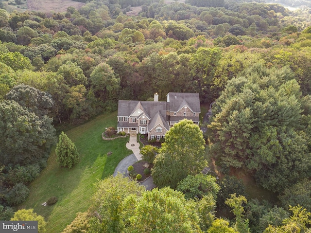 birds eye view of property featuring a view of trees