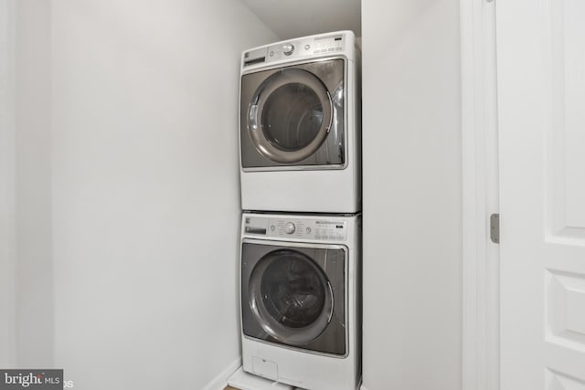 laundry room with stacked washing maching and dryer and laundry area