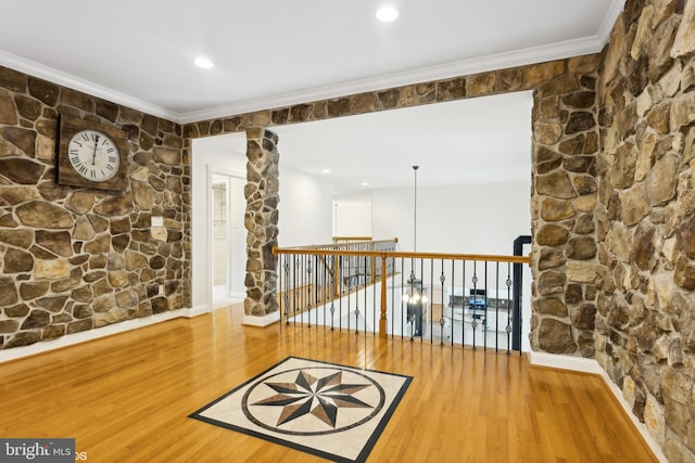 hall with hardwood / wood-style flooring and ornamental molding