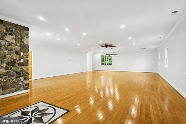 unfurnished living room featuring light wood-type flooring, crown molding, and ceiling fan