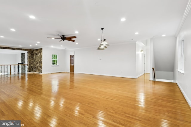 interior space featuring ornamental molding, light hardwood / wood-style floors, and ceiling fan