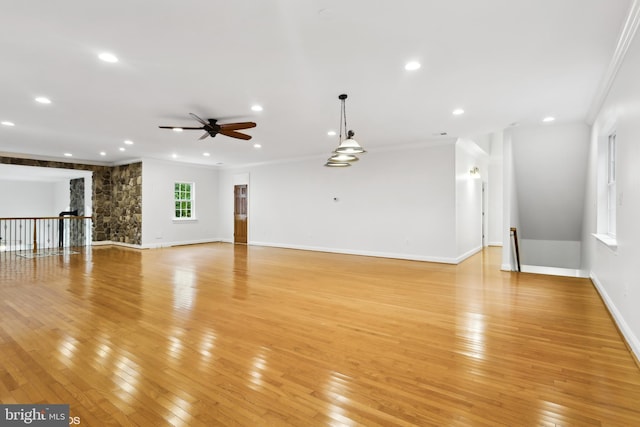 unfurnished living room featuring crown molding, recessed lighting, light wood-type flooring, baseboards, and a ceiling fan
